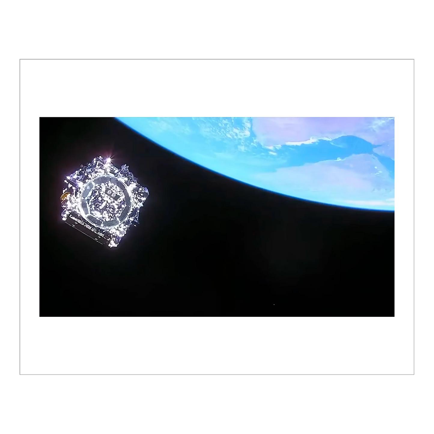 The The James Webb Space Telescope floating in space away from earth, as it detaches from the its launch rocket.