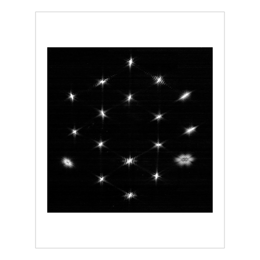 A star partially out of focus, repeated 18 times, once for each of the Webb’s mirrors, into a hexagonal formation.